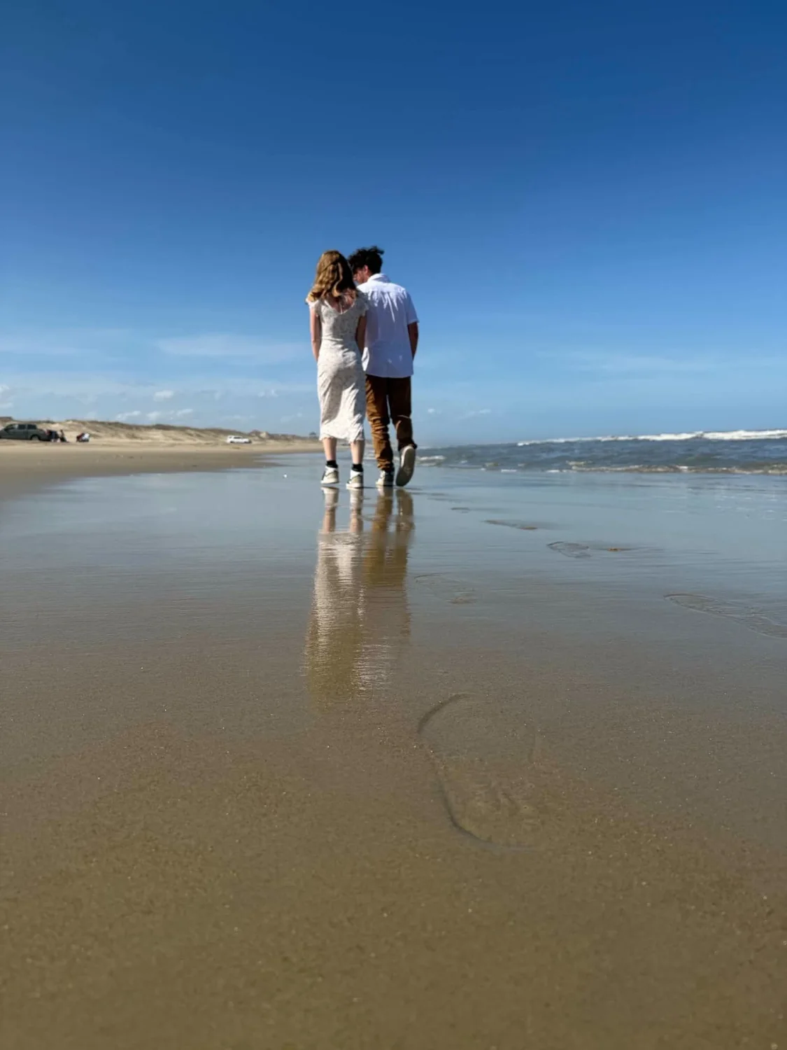 Nathan and Piper walking along the beach