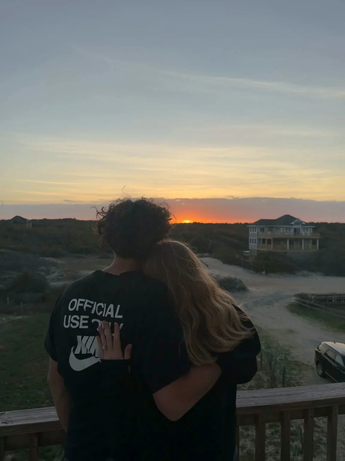 Nathan and Piper embracing at sunset